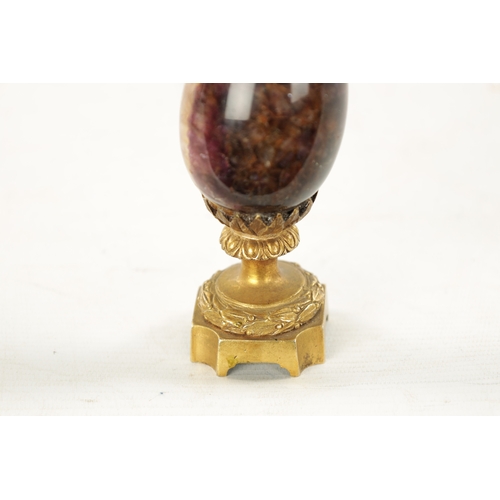 942 - A 19TH CENTURY ORMOLU MOUNTED BLUE JOHN URN with leaf cast finial and matching base. (15cm high)