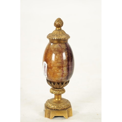 942 - A 19TH CENTURY ORMOLU MOUNTED BLUE JOHN URN with leaf cast finial and matching base. (15cm high)