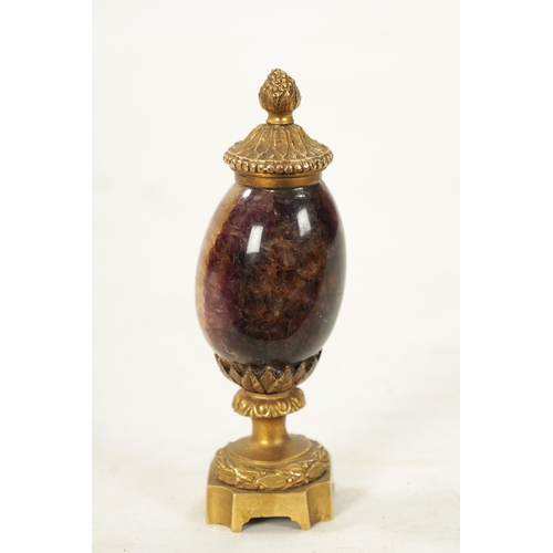 942 - A 19TH CENTURY ORMOLU MOUNTED BLUE JOHN URN with leaf cast finial and matching base. (15cm high)