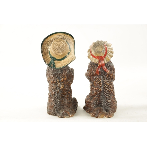 948 - A PAIR OF LATE 19TH CENTURY AUSTRIAN COLD-PAINTED TERRACOTTA MODELS OF DOGS seated with hats and one... 