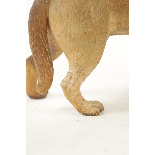 962 - A LATE 19TH CENTURY COLD PAINTED TERRACOTTA MODEL OF A PUG DOG with glass eyes. (22cm high )