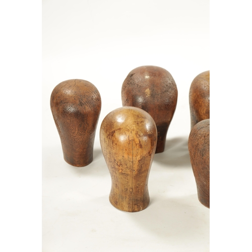 965 - A COLLECTION OF THIRTEEN 19TH CENTURY WOODEN WIG STANDS bearing the label 