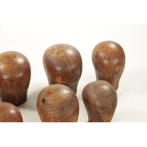 965 - A COLLECTION OF THIRTEEN 19TH CENTURY WOODEN WIG STANDS bearing the label 