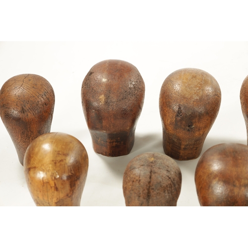 965 - A COLLECTION OF THIRTEEN 19TH CENTURY WOODEN WIG STANDS bearing the label 