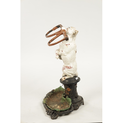 985 - A 19TH CENTURY CAST IRON NOVELTY STICKSTAND modelled as a Jack Russell dog standing on hind legs hol... 