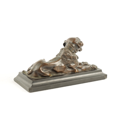 990 - A 19TH CENTURY PATINATED BRONZE SCULPTURE modelled as a recumbent bull mastif dog mounted on a mould... 