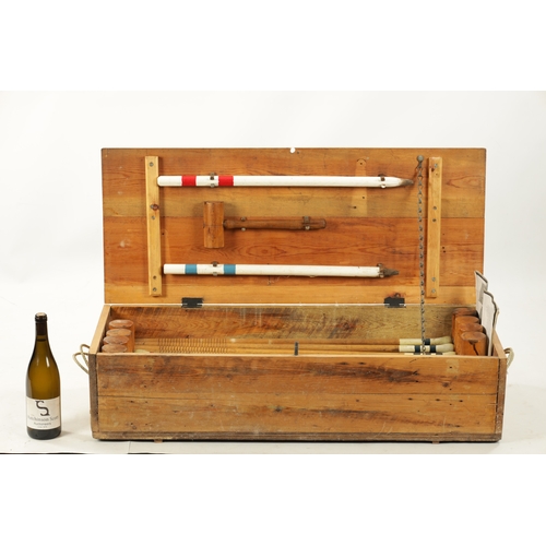 991 - AN EDWARDIAN CROQUET SET complete with eight mallets in pine box (96cm wide )