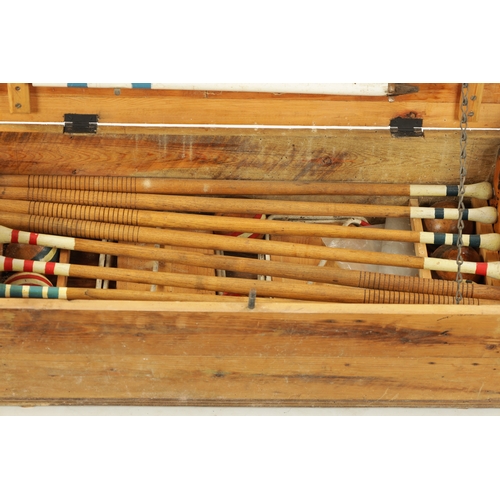 991 - AN EDWARDIAN CROQUET SET complete with eight mallets in pine box (96cm wide )