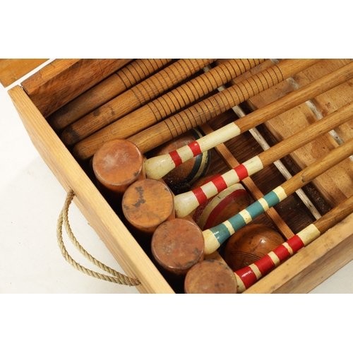 991 - AN EDWARDIAN CROQUET SET complete with eight mallets in pine box (96cm wide )