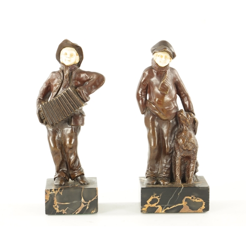 997 - A PAIR OF ARTS AND CRAFTS BRONZE AND IVORY FIGURES depicting a boy and his dog and a boy playing a s... 