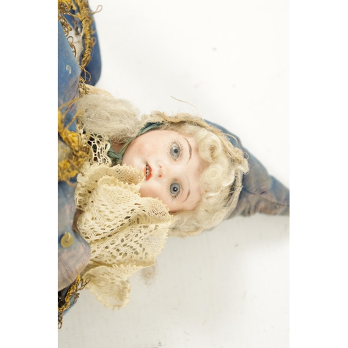 999 - A LATE 19TH CENTURY BISQUE SOCKET HEAD DOLL / JESTER painted open mouth, blue glass eyes wearing roy... 