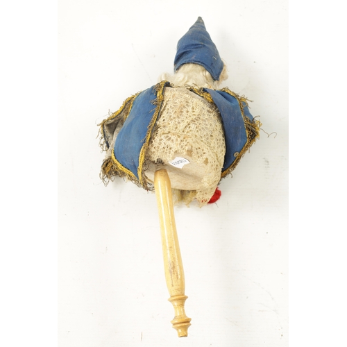 999 - A LATE 19TH CENTURY BISQUE SOCKET HEAD DOLL / JESTER painted open mouth, blue glass eyes wearing roy... 