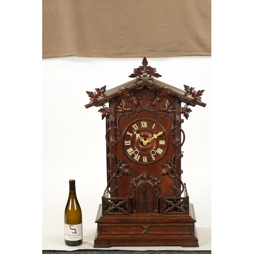 1201 - A LARGE LATE 19TH CENTURY BLACK FOREST TRUMPETER CLOCK the leaf-carved architectural walnut case wit... 