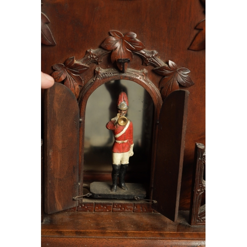 1201 - A LARGE LATE 19TH CENTURY BLACK FOREST TRUMPETER CLOCK the leaf-carved architectural walnut case wit... 