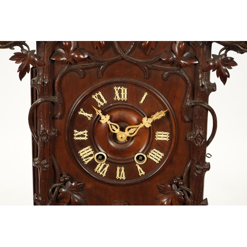 1201 - A LARGE LATE 19TH CENTURY BLACK FOREST TRUMPETER CLOCK the leaf-carved architectural walnut case wit... 