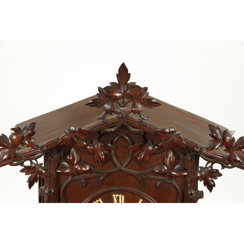 1201 - A LARGE LATE 19TH CENTURY BLACK FOREST TRUMPETER CLOCK the leaf-carved architectural walnut case wit... 