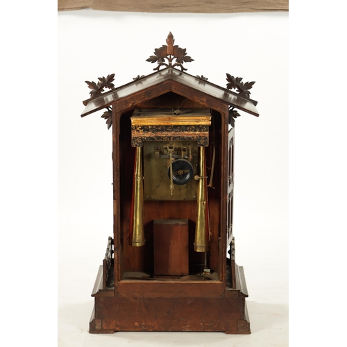 1201 - A LARGE LATE 19TH CENTURY BLACK FOREST TRUMPETER CLOCK the leaf-carved architectural walnut case wit... 