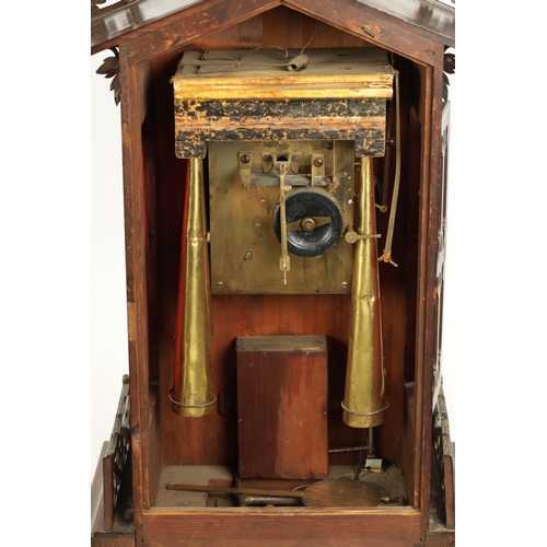 1201 - A LARGE LATE 19TH CENTURY BLACK FOREST TRUMPETER CLOCK the leaf-carved architectural walnut case wit... 