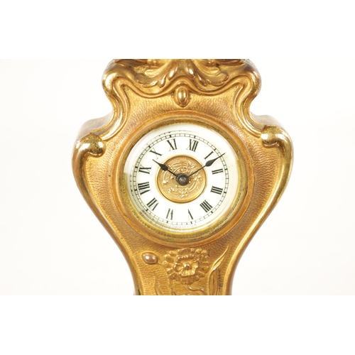 1253 - A GILT BRONZE ART NOUVEAU MANTEL CLOCK the floral shaped case enclosing an enamel Roman dial frontin... 