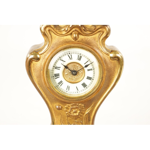 1253 - A GILT BRONZE ART NOUVEAU MANTEL CLOCK the floral shaped case enclosing an enamel Roman dial frontin... 