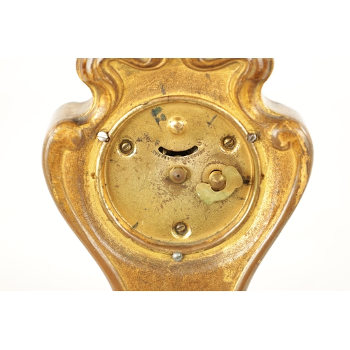 1253 - A GILT BRONZE ART NOUVEAU MANTEL CLOCK the floral shaped case enclosing an enamel Roman dial frontin... 