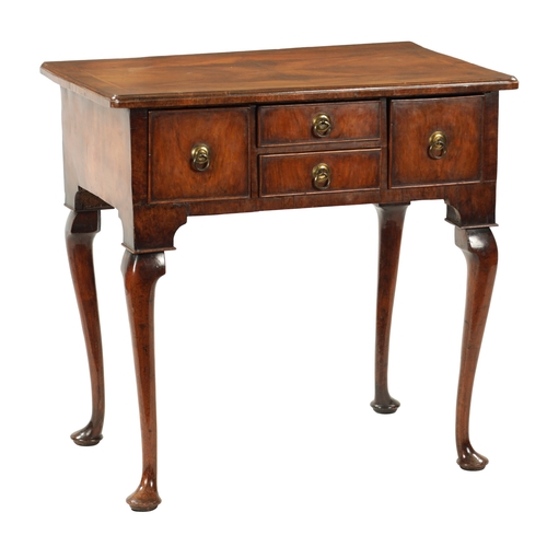 1499 - A QUEEN ANNE FIGURED WALNUT LOWBOY with quarter veneered top above four drawers with round brass han... 