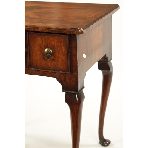 1499 - A QUEEN ANNE FIGURED WALNUT LOWBOY with quarter veneered top above four drawers with round brass han... 