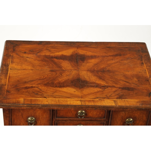 1499 - A QUEEN ANNE FIGURED WALNUT LOWBOY with quarter veneered top above four drawers with round brass han... 