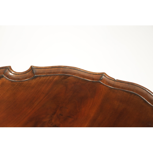 1505 - AN EARLY 19TH CENTURY MAHOGANY TILT TOP TABLE with shaped flamed pie crust top; raised on an elabora... 