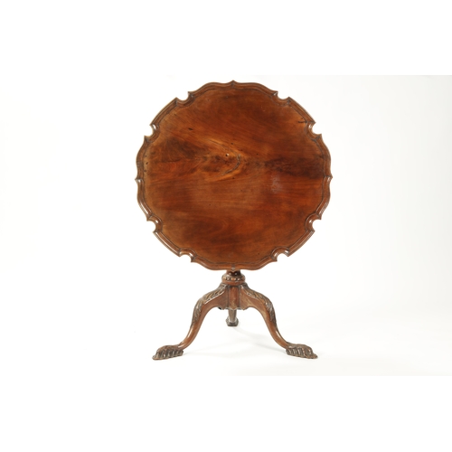 1505 - AN EARLY 19TH CENTURY MAHOGANY TILT TOP TABLE with shaped flamed pie crust top; raised on an elabora... 