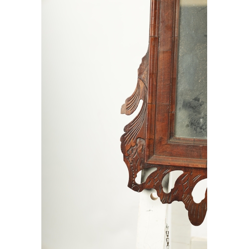 4 - A LARGE MID 18TH CENTURY WALNUT HANGING MIRROR with fret-cut shaped surround enclosing a rectangular... 