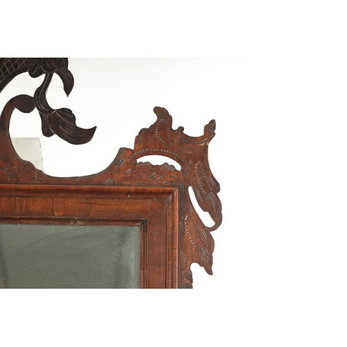 4 - A LARGE MID 18TH CENTURY WALNUT HANGING MIRROR with fret-cut shaped surround enclosing a rectangular... 