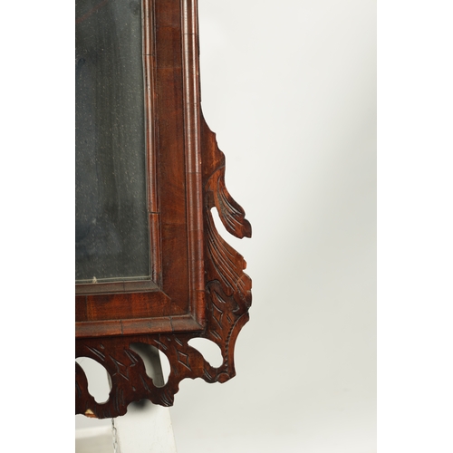 4 - A LARGE MID 18TH CENTURY WALNUT HANGING MIRROR with fret-cut shaped surround enclosing a rectangular... 