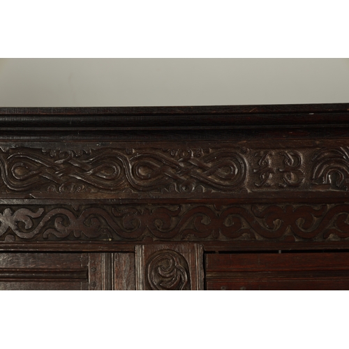 71 - A GOOD LATE 17TH CENTURY OVERSIZED CARVED OAK WESTMORLAND COURT CUPBOARD DATED 1673 having carved fr... 