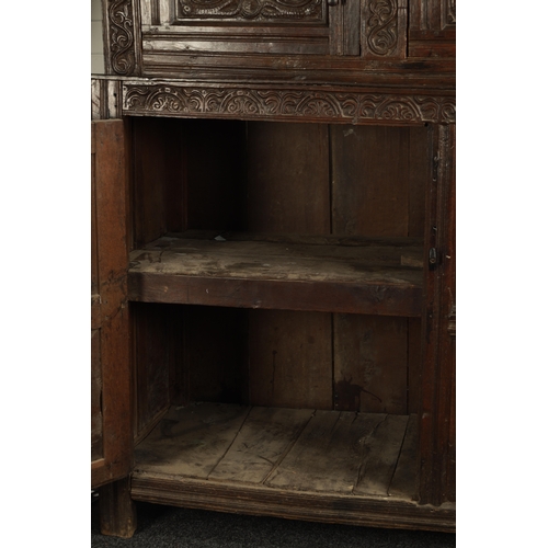 71 - A GOOD LATE 17TH CENTURY OVERSIZED CARVED OAK WESTMORLAND COURT CUPBOARD DATED 1673 having carved fr... 