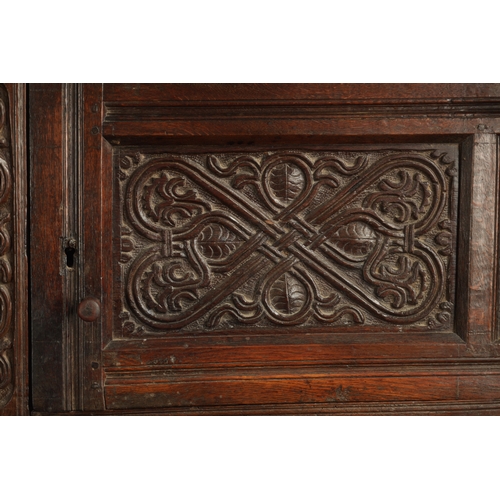 71 - A GOOD LATE 17TH CENTURY OVERSIZED CARVED OAK WESTMORLAND COURT CUPBOARD DATED 1673 having carved fr... 