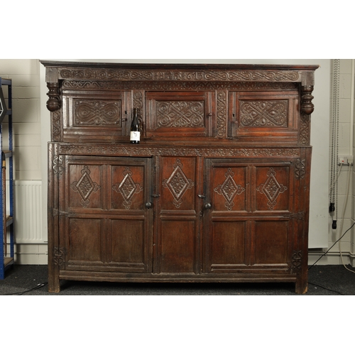 71 - A GOOD LATE 17TH CENTURY OVERSIZED CARVED OAK WESTMORLAND COURT CUPBOARD DATED 1673 having carved fr... 