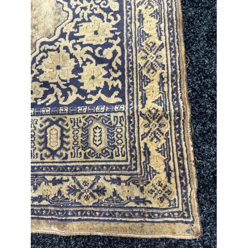 386 - AN ANTIQUE EASTERN PRAYER RUG (108cm wide 60cm deep)