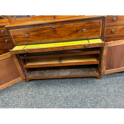 1502 - A FINE GEORGE III SHERATON DESIGN INLAID MAHOGANY BREAKFRONT BOOKCASE with shaped pediment and finia... 