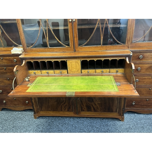 1502 - A FINE GEORGE III SHERATON DESIGN INLAID MAHOGANY BREAKFRONT BOOKCASE with shaped pediment and finia... 