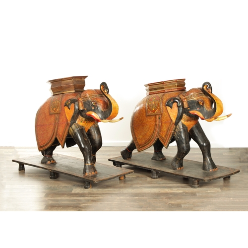 107 - A GOOD PAIR OF LARGE-SIZED 19TH CENTURY INDIAN CARVED WOOD AND LACQUERED ELEPHANTS decorated with Ka... 