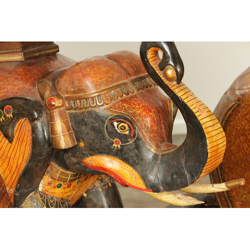 107 - A GOOD PAIR OF LARGE-SIZED 19TH CENTURY INDIAN CARVED WOOD AND LACQUERED ELEPHANTS decorated with Ka... 