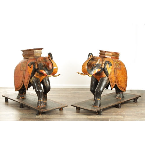 107 - A GOOD PAIR OF LARGE-SIZED 19TH CENTURY INDIAN CARVED WOOD AND LACQUERED ELEPHANTS decorated with Ka... 
