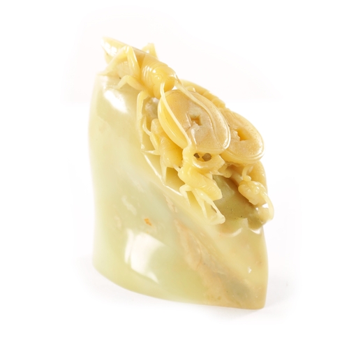 112 - A CARVED CHINESE JADE SCULPTURE depicting grasshopper and insects carrying Chinese coins. (9cm high)