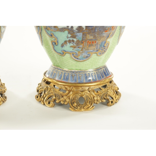 117 - A PAIR OF 18TH/19TH CENTURY CHINESE ORMOLU MOUNTED VASES decorated with pagoda landscape panels with... 