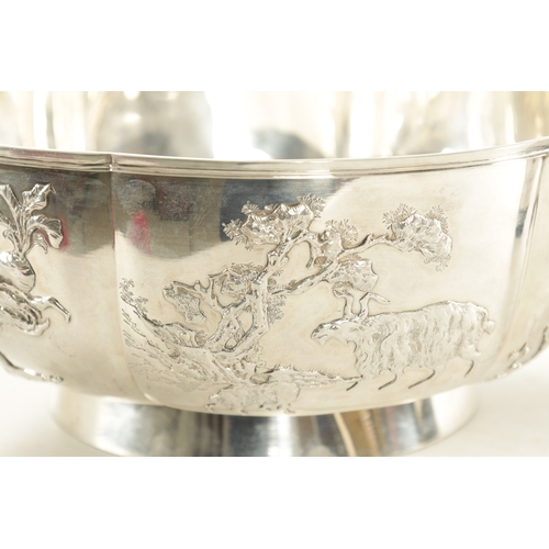 124 - AN EARLY 20TH CENTURY LARGE CHINESE SILVER BOWL of shaped form with relief work decoration to the ou... 