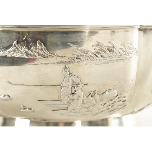 124 - AN EARLY 20TH CENTURY LARGE CHINESE SILVER BOWL of shaped form with relief work decoration to the ou... 