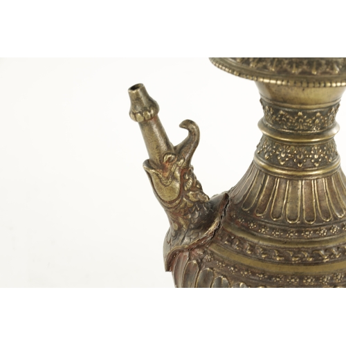 129 - AN EARLY INDIAN ISLAMIC BRONZE HUKA BASE with an elephant-shaped spout and floral decoration (29cm h... 