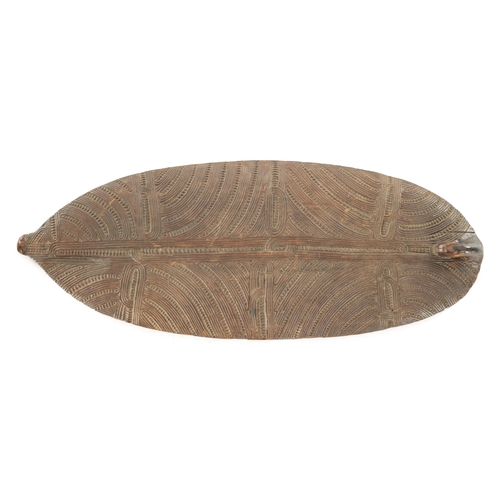 133 - AN EARLY 19TH CENTURY MAORI WAKA HUIA / FEATHER BOX COVER the carved hardwood cover decorated with c... 
