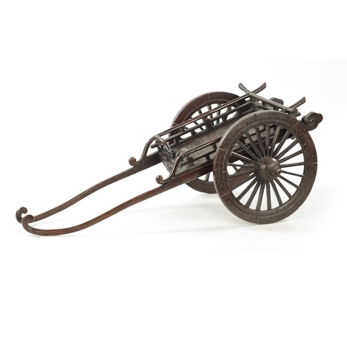 135 - A JAPANESE MEIJI PERIOD PATINATED BRONZE MODEL OF A CARRIAGE with floral decoration and spoke wheels... 